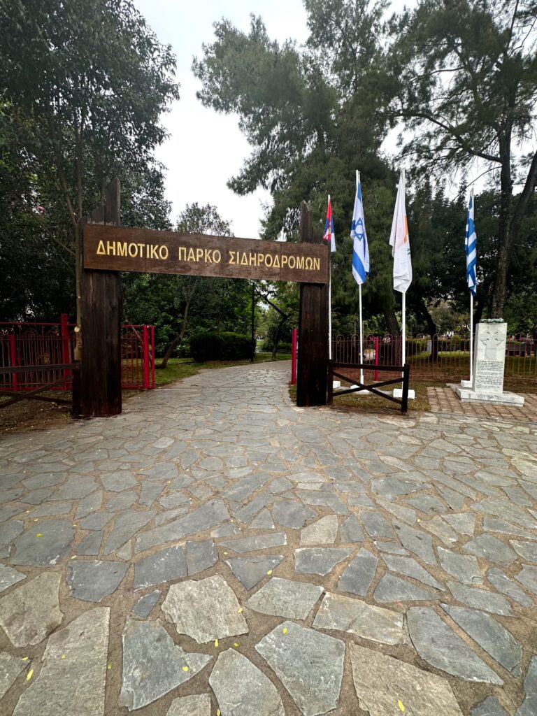 View of Kalamata OSE Park showcasing historical trains and lush green landscapes, offering a glimpse into the city's railway heritage.