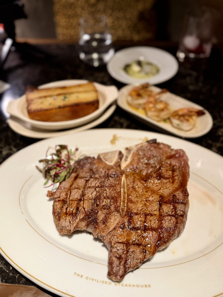 Bone-in filet steak served with grilled shrimp appetizer and house specialties at The Prime Rib inside Live! Casino & Hotel Louisiana. 