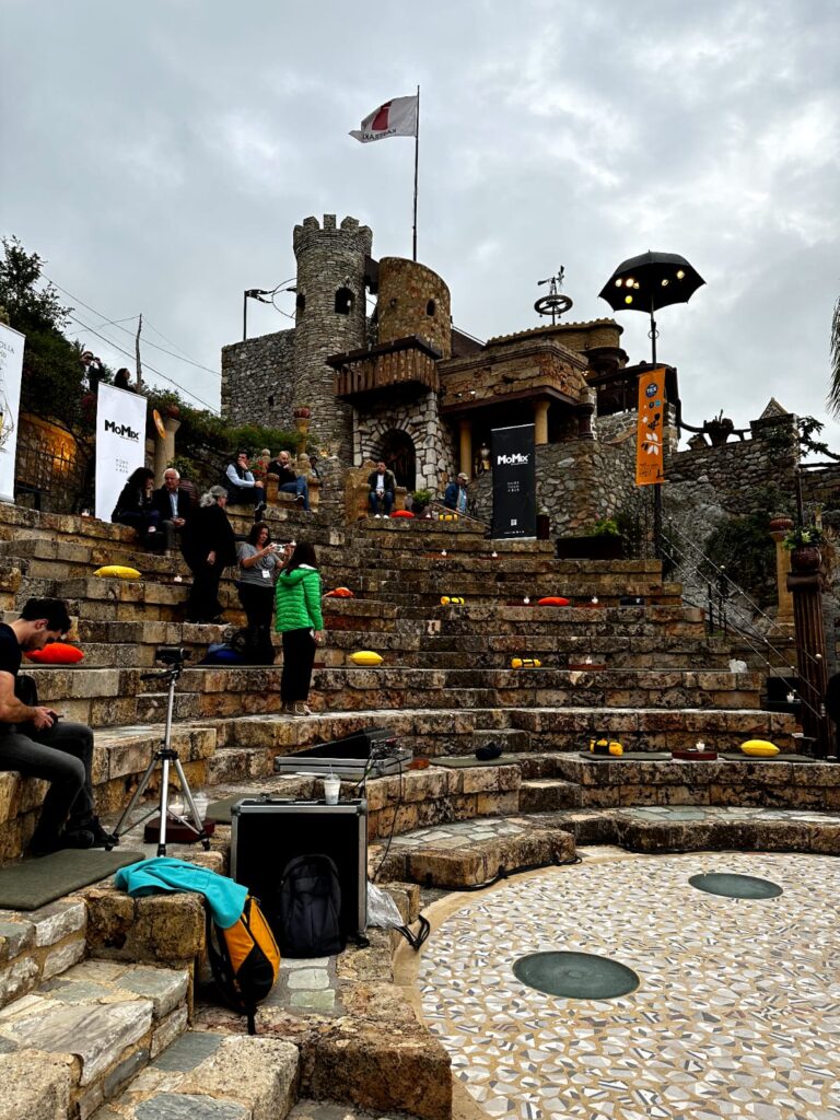 Breathtaking view of Kastraki village nestled at the base of the towering Meteora rock formations, surrounded by lush greenery and ancient monasteries.